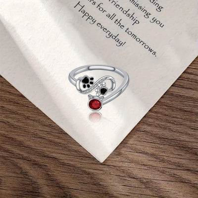 Verstellbarer Ring mit schwarzen Pfotenabdrücken & rotem Edelstein